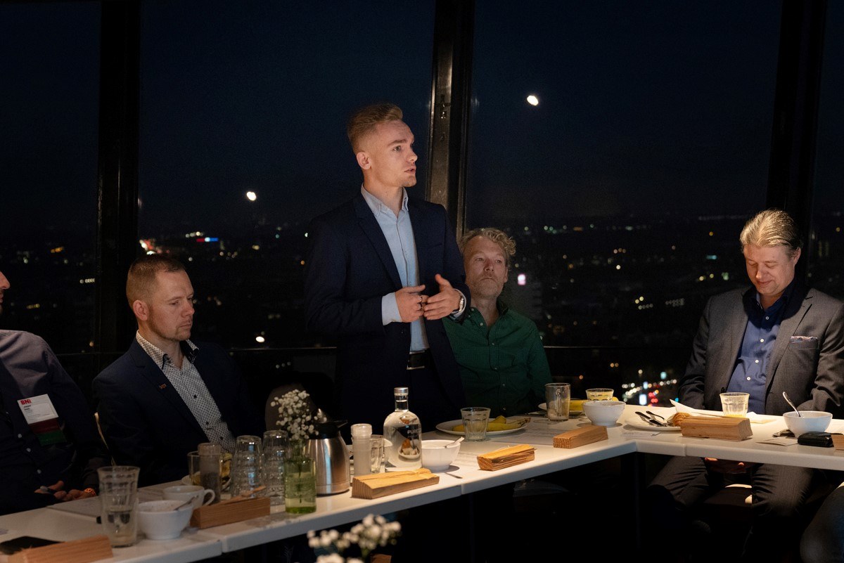 Len P. van der Hof speaking at a dinner event